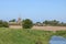 Rural view, small river, ploughed field and church