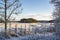 Rural view in winter, fence, snowy trees and field, Eestinkyla village, Kirkkonummi, Finland
