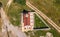 Rural village isolated by a dirt path with an orthodox church. Bulgaria by drone