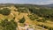 rural village isolated by a dirt path with an orthodox church. Bulgaria by drone