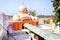 A rural village landscape consisting of lush greenery, a Hindu temple