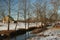 Rural winter landscape with creek and barn