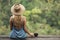 Rural woman with cup of coffee siting and look on jungle.