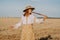 Rural woman plays on wooden flute - ukrainian telenka, tylynka in wheat field. Folk music, sopilka concept. Musical