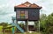 The rural wooden house with a decoration standing on a high pillars, Cambodia