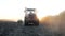 Rural work land by agriculture equipment or tractor at sunset field, nature farm