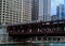 Rush hour scene of Chicago`s elevated `el` train track passing over the Chicago River.