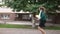 Rushing overweight Caucasian adult woman running in slow motion on city street. Side view wide shot plus-size hurrying