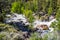 Rushing Rapids In Mountain Stream From Snow Melt