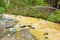 Rushing water muddied by placer mining in northern canada