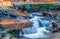 Rushing water over fall leaves