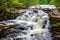 rushing waterfall cascading into a river