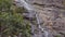 Rushing waterfall in the mountains with tropical forest. Beautiful nature background. Close up