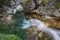 rushing waterfall with rocks in the mountains