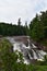 Rushing waterfall in a wilderness area on a hazy summer day