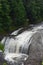 Rushing waterfall in a wilderness area on a hazy summer day