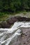 Rushing waterfall in a wilderness area on a hazy summer day