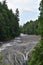 Rushing waterfall in a wilderness area on a hazy summer day