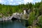 Ruskeala, Russia - June 14, 2022: View of the Great Marble Canyon of Ruskeala Mountain Park in Karelia. People are boating on the