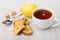 Rusks with raisin, tea, lemon, lumpy sugar and teaspoon