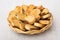 Rusks with raisin in wicker basket on table