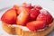 A rusks with strawberries with sugar on a white plate. Selective focus