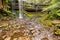 Russell Falls, tieredâ€“cascade waterfall with stone covered wit