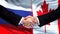 Russia and Canada handshake, international friendship summit, flag background