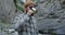 Russia, Caucasus. Young man drinks from a mug, standing near a mountain river