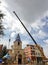 Russia, Chelyabinsk, 08/20/2020. A crane mounts the dome on the church. Repair and restoration of the temple in Europe.