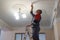 Russia, city of Magnitogorsk, - August, 9, 2016. Installation and adjustment of the fire alarm system in a public room