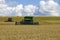 Russia , Dmitrov - 2 August 2019 : Combine harvester harvesting wheat on sunny summer day