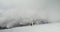 Russia, , Elbrus. Climbers descend from along a snow-covered rocky slope