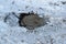 RUSSIA - FEBRUARY, 2018: Sewer manhole on the road in winter