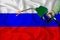 RUSSIA flag Close-up shot on waving background texture with Fuel pump nozzle in hand. The concept of design solutions. 3d