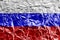 Russia flag depicted in paint colors on shiny crumpled aluminium foil closeup. Textured banner on rough background