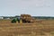 Russia. Gatchinsky district of the Leningrad region. August 28, 2021. A tractor takes away rolls of hay from the field.