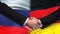 Russia and Germany handshake, international friendship summit, flag background