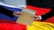 Russia and Germany officials exchanging confidential envelope, flags background