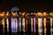 Russia, Irkutsk - July 19, 2019: Colorfull reflection of Ferris wheel and lights in Angara river, night photo near