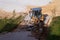 Russia, Kaluga - OCTOBER 27, 2020: Tractor breaking the old asphalt with a bucket before the construction