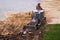 Russia, Kaluga - OCTOBER 27, 2020: Tractor breaking the old asphalt with a bucket before the construction