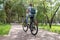 Russia, Kamensk Uralsky, august 10, 2019. a girl with a backpack on her back rides along a path in a Park on a Bicycle on a summer