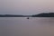 Russia, Karelia. White nights. Lake Muezero. Tourists on an inflatable boat floating on the lake