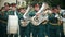 RUSSIA, KAZAN 09-08-2019: A wind instrument parade - military musicians in green costumes walking on the street holding