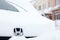 Russia Kemerovo 2018-12-23 closeup front of Honda Stepwgn minibus car, metal emblem brand icon covered fluffy snow. Concept