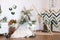 Russia Kemerovo 2019-04-15 Spring design of interior photo studio: wooden triangle frames, wicker wreaths, basket, straw, bouquet