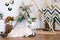 Russia Kemerovo 2019-04-15 Spring design of interior photo studio: wooden triangle frames, wicker wreaths, basket, straw, bouquet