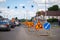 Russia, Kemerovo 2019-07-11 asphalt road repairs, yellow warning triangle signs about road works and bypass directions