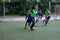 Russia, Khabarovsk - Jun 11, 2019: street domestic playing soccer. Young guys play soccer on a green grass